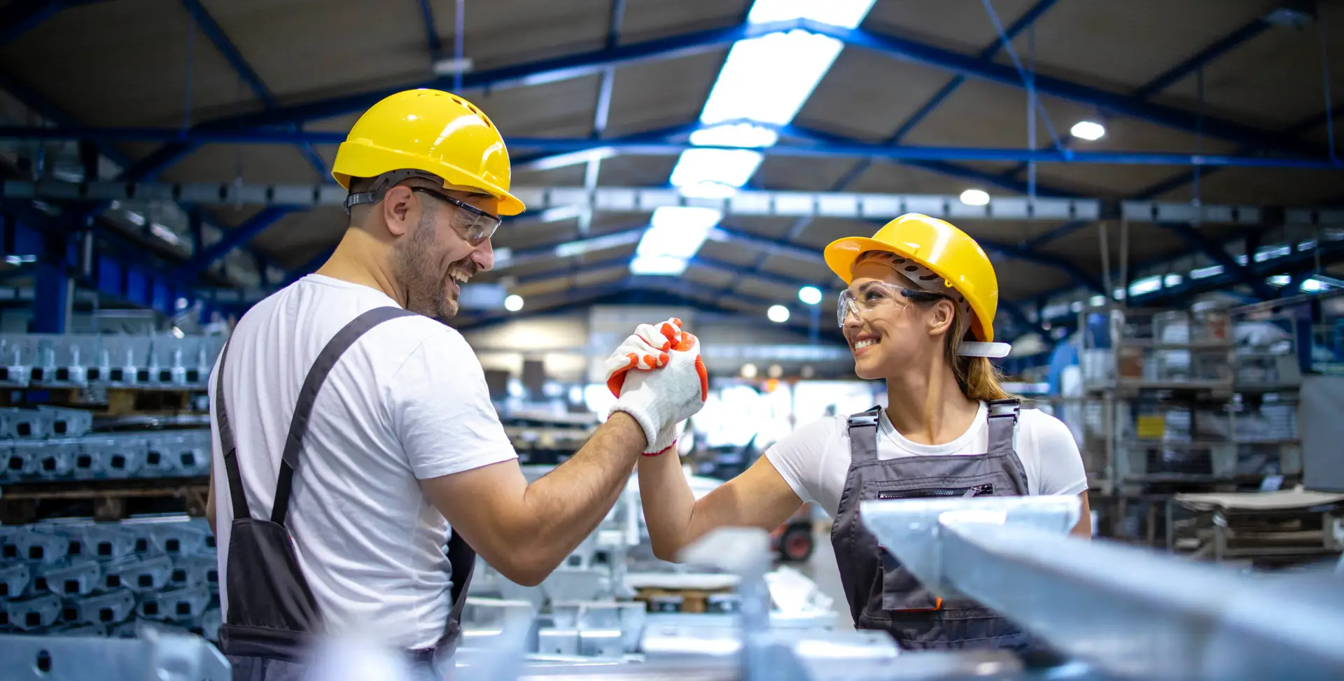 factory workers handshaking each other at production line.